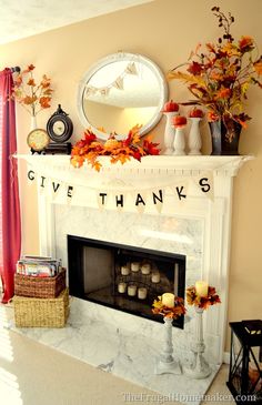 a white fireplace with a sign that says give thanks