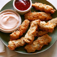 a plate filled with fried food and dipping sauce