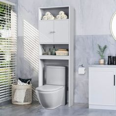 a white toilet sitting next to a bathroom sink