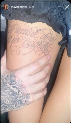 a woman's thigh with tattoos and writing on it