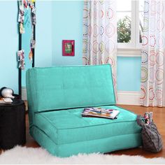 a blue couch sitting in front of a window