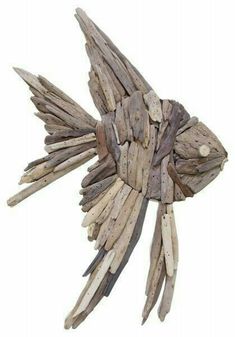 a fish made out of drift wood on a white background