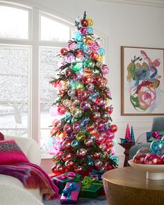 a brightly colored christmas tree in a living room