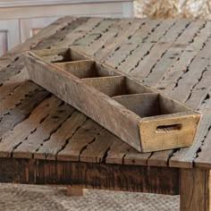 an old wooden table with two trays sitting on it's top and bottom