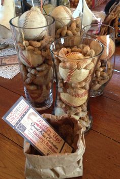 three glass vases filled with nuts sitting on top of a wooden table next to each other