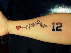 a wrist tattoo with the number twelve and heartbeat on it's left arm that reads 12