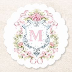 the letter m is surrounded by pink flowers and ribbons on a white doily with an ornate frame