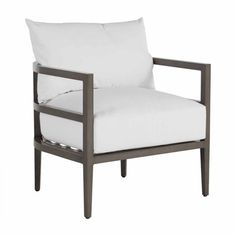 a chair with white pillows on it and a wooden frame around the armrests