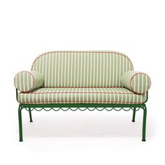 a green and white striped couch sitting on top of a metal frame