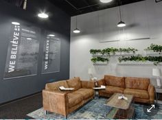 a living room with two couches and a coffee table in front of the wall