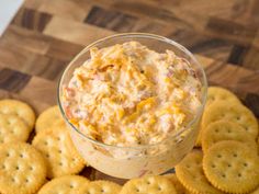 a bowl of dip with crackers on the side