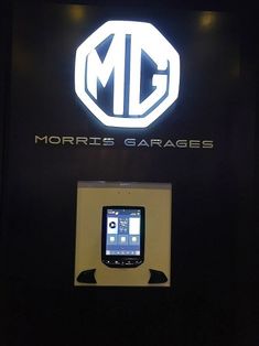 a cell phone is on display in front of a sign that says morrie's garages