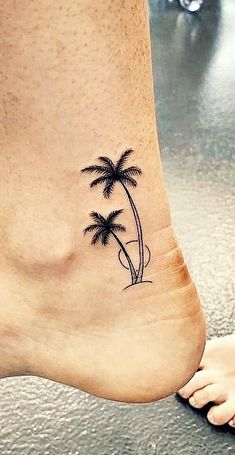 a small palm tree tattoo on the side of a woman's foot is shown