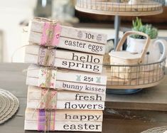 a stack of books sitting on top of a table next to a basket filled with eggs