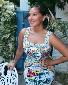 a woman standing next to a white chair