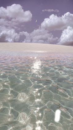 the water is crystal clear and there are clouds in the sky