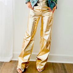 Night Out Metallic Pants Metallic Straight Pant These Metallic Straight Pants Are Sure To Elevate Any Outfit. Constructed With A Luxe Elastic Fabric, These High-Shine Pants Feature A Classic Straight Leg Silhouette And Side Pockets For Added Convenience And Style. Make A Bold Statement With These On-Trend Metallic Pants. Product Detail Size-Small Fits Up To A Size 2 Color: Gold Casual Gold Wide Leg Bottoms, Gold Party Bottoms With Pockets, Non-stretch Wide Leg Leather Pants For Spring, Gold Bottoms With Pockets For Fall, Gold Pants For Night Out In Summer, Gold Long Pants For Summer, Wide Leg Leather Pants With Pockets For Party, Party Wide-leg Pants With Pockets, Trendy Gold Bottoms For Fall