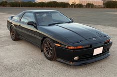 a black sports car parked in a parking lot