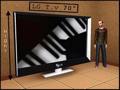 a man standing in front of a flat screen tv next to a keyboard on the floor