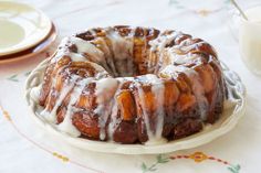 a bundt cake sitting on top of a white plate next to a glass of milk