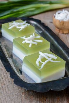 three pieces of soap sitting on top of a metal tray