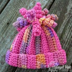 a crocheted hat sitting on top of a wooden table