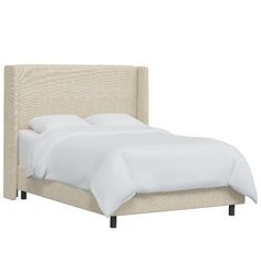 a bed with white linens and pillows on top of the headboard, in front of a white background