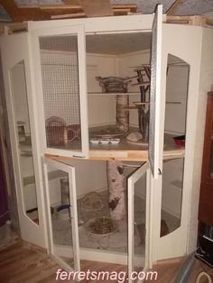 an open cabinet in the corner of a room