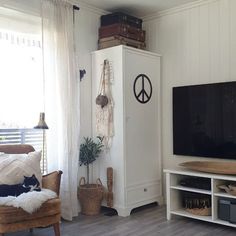 a living room filled with furniture and a flat screen tv on top of a wooden stand