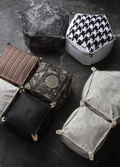 four pieces of luggage sitting on top of a floor next to each other with different patterns