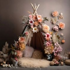 a teepee decorated with flowers and feathers