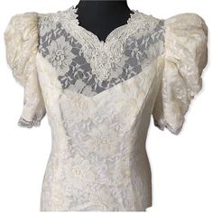 the back of a white dress with lace on it