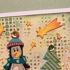 a close up of a card with a penguin and christmas trees on the bottom right corner