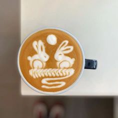 a cappuccino with an image of two rabbits on it