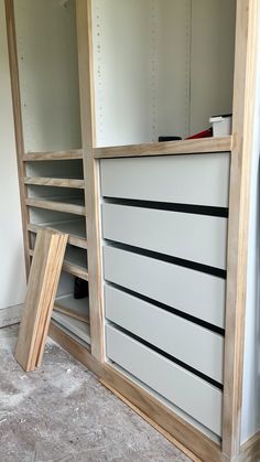 an empty storage unit with drawers and shelves