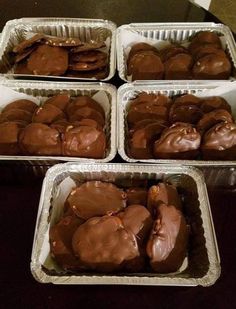 four pans filled with brownies sitting on top of a table