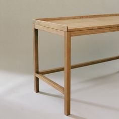 a wooden table sitting on top of a white floor