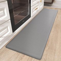 an oven door mat on the floor in a kitchen