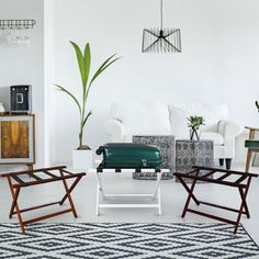 a living room filled with furniture and a green grill on top of a table in front of a white couch