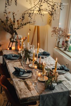 a wooden table topped with lots of candles