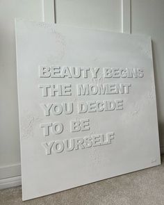 a white sign that says beauty begins the moment you decide to be yourself on it