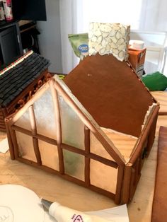 a doll house made out of wood sitting on top of a table