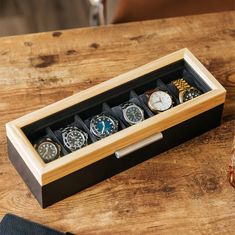 A Modern Take On Watch Storage Introducing the Two-Toned Solid Pine Watch Case by Case Elegance. We have meticulously crafted every detail of this watch box, from the magnets embedded into the solid wood lid, soft plush interior, real tempered glass top, and a bold and modern aluminum lift handle. Store up to six watches with our included ultra-soft watch pillows that compress to fit several different sizes and types of watches. Stop placing your nice watches in the top drawer of your nightstand Watch Cabinet, Brown Rectangular Watch Case For Formal Occasions, Luxury Rectangular Watch Storage Accessories, Luxury Modern Watch Accessories Box, Business Brown Rectangular Watch Case, Luxury Watch Box, Classic Rectangular Watch Storage Box, Wooden Watch Box, Mens Jewelry Box