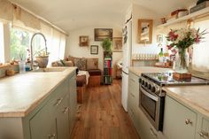 a kitchen filled with lots of counter space next to a stove top oven and microwave