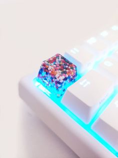 a close up of a computer keyboard with colorful sprinkles on it