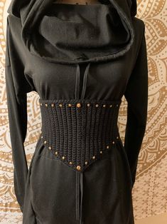 a black dress with gold buttons on it