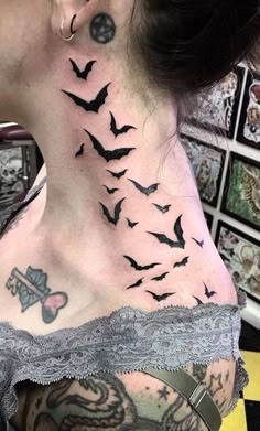 a woman's back neck with many bats on it