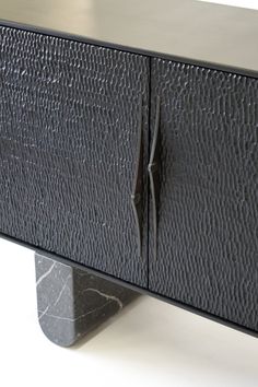 a black cabinet with two doors on it