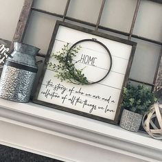 a sign that is on top of a mantle with some plants in front of it