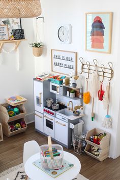 a child's playroom with toys and accessories on the floor, including an oven